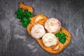 Garlic cloves and garlic bulb on a wooden board on a gray background. Royalty Free Stock Photo