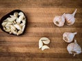Garlic cloves kept in wooden chopping board,Daylight Royalty Free Stock Photo