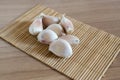 Garlic cloves on makisu mat on wood texture Royalty Free Stock Photo