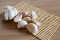 Garlic cloves on makisu mat on wood texture Royalty Free Stock Photo