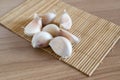 Garlic cloves on makisu mat on wood texture Royalty Free Stock Photo