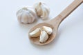 Garlic cloves in wooden cooking spoon