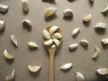 Garlic Cloves in a Wooden spoon on the MDF wooden plate board Texture Backgroun Royalty Free Stock Photo