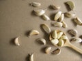 Garlic Cloves in a Wooden spoon on the MDF wooden plate board Texture Background Royalty Free Stock Photo