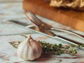 Garlic cloves on wooden vintage background in cafe, fork and knife on background Royalty Free Stock Photo