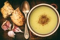 Garlic cream soup with cheese on brown wooden background. Royalty Free Stock Photo