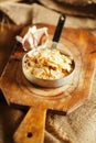 Garlic dried flakes and bulb on old wooden board