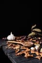 Garlic, dried fruit and seeds in dark rustic background