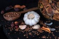 Garlic, dried fruit and seeds in dark rustic background