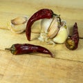 Garlic and dry chili pepper on the background of a wooden table. fresh garlic and dried chili peppers. Dried red pepper Royalty Free Stock Photo