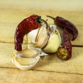 Garlic and dry chili pepper on the background of a wooden table. fresh garlic and dried chili peppers. Dried red pepper Royalty Free Stock Photo