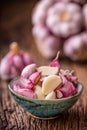 Garlic. Fresh garlic bulbs on old wooden board. Red violet garlic