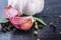 Garlic. Fresh Garlic. Cloves of garlic with parsley herb top leaves and pepper four colours Royalty Free Stock Photo