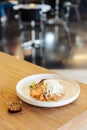 Garlic fried rice with grilled salmon served with spicy bean sauce on wooden table with blur background Royalty Free Stock Photo