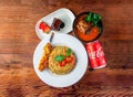 garlic fried rice with skewer, chicken satay, brownie and coke can 330 ml served in dish isolated on wooden table top view of hong