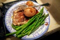 Garlic glazed pork chop with new potatoes and steamed asparagus spears Royalty Free Stock Photo