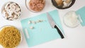 Garlic gloves close up on cutting board on white kitchen table, flat lay, copy space. Royalty Free Stock Photo