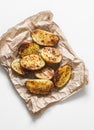 Garlic grilled potatoes baked on a light background top view