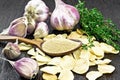 Garlic ground in spoon on dark board Royalty Free Stock Photo