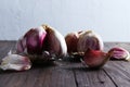Garlic heads and cloves on dark wooden surface