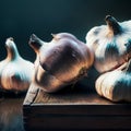garlic heads on a wooden table. contrast lighting