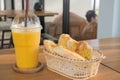 Garlic with herb bread and sweet yellow mango smoothie on wood table Royalty Free Stock Photo