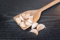 Garlic herb whole cloves in wooden spoons over wooden table