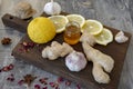 Garlic, lemon, honey, ginger and various spices on a rough wooden Board Royalty Free Stock Photo