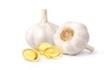 Garlic oil capsules with garlic bulbs Royalty Free Stock Photo