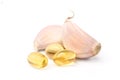 Garlic oil capsules with garlic cloves Royalty Free Stock Photo