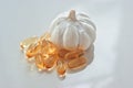 Garlic oil capsules on a white reflective surface Royalty Free Stock Photo