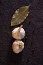 Garlic, onion, bay leaf, black pepper on textile background. Food background. Garlics. sliced garlic, garlic clove, garlic bulb.