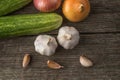 Garlic, onion, cucumber, potatoes and tomato on an old table Royalty Free Stock Photo