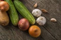 Garlic, onion, cucumber, potatoes and tomato on an old table Royalty Free Stock Photo