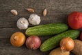 Garlic, onion, cucumber, potatoes and tomato on an old table Royalty Free Stock Photo