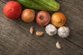 Garlic, onion, cucumber, potatoes and tomato on an old table Royalty Free Stock Photo