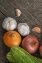 Garlic, onion, cucumber, potatoes and tomato on an old table Royalty Free Stock Photo