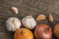 Garlic, onion and potatoes on an old table Royalty Free Stock Photo