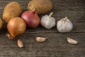 Garlic, onion and potatoes on an old table Royalty Free Stock Photo