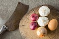 Garlic,onion,shallot,egg on cutting board Royalty Free Stock Photo