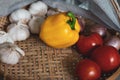 Garlic, onions, tomatoes and peppers In a basket Royalty Free Stock Photo