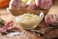 Garlic paste in a glass bowl with peeled garlic, salt and garlic heads