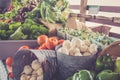 Garlic, peppers and tomatoes for sale in baskets at the farmer`s market for fall harvest