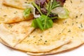 Garlic pita bread pizza with salad on top