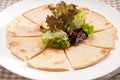 Garlic pita bread pizza with salad on top