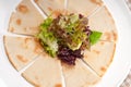 Garlic pita bread pizza with salad on top