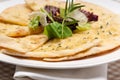 Garlic pita bread pizza with salad on top