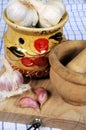 Garlic pot with pestle and mortar. Royalty Free Stock Photo