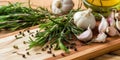 Garlic Rosemary and peppercorns on a wooden chopping board