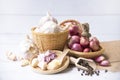 Garlic,shallot,Black pepper, fresh garlic, garlic clove, garlic bulb and shallot in a wooden basket on white wooden table, A herb